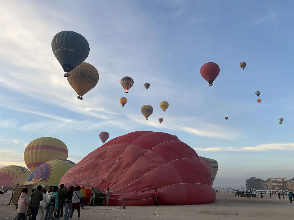Hot air balloons rising over the West Bank of Luxor